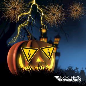 A spooky scene with a pumpkin, fireworks and haunted house in the background.