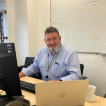 Andrew Webster at his desk