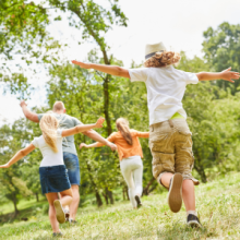 Children and adults playing outside in the spring weather