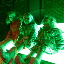 Children sitting on an illuminated bench