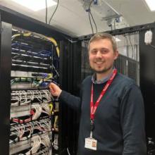 Tom Skeet stood in front of a computer server