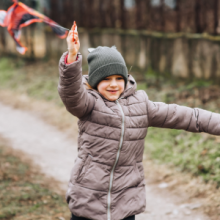 Young boy playing with a kite 